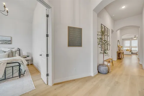 a bedroom with a bed and a potted plant