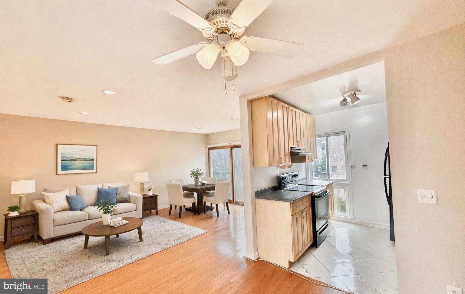 a living room with stainless steel appliances kitchen island furniture and a chandelier