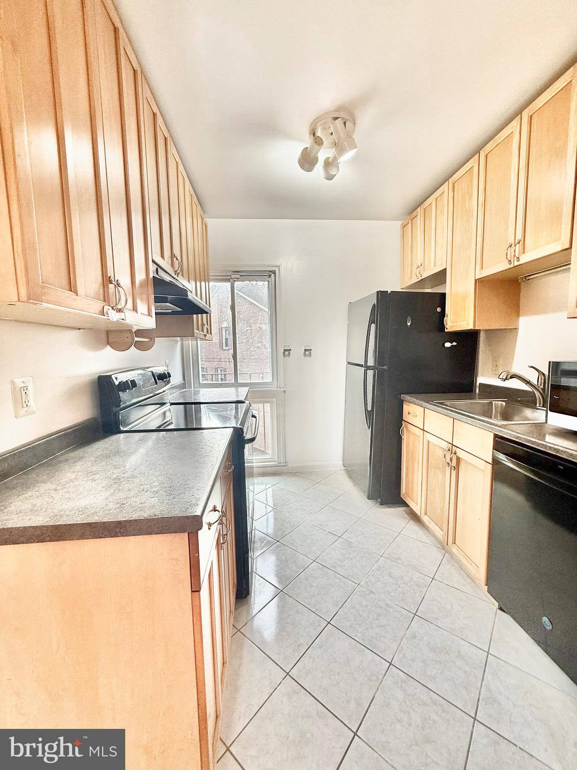 720 West Glebe Road, Unit 2C Alexandria, VA 22305 - Photo 3 of 13 a kitchen with a sink a refrigerator and cabinets