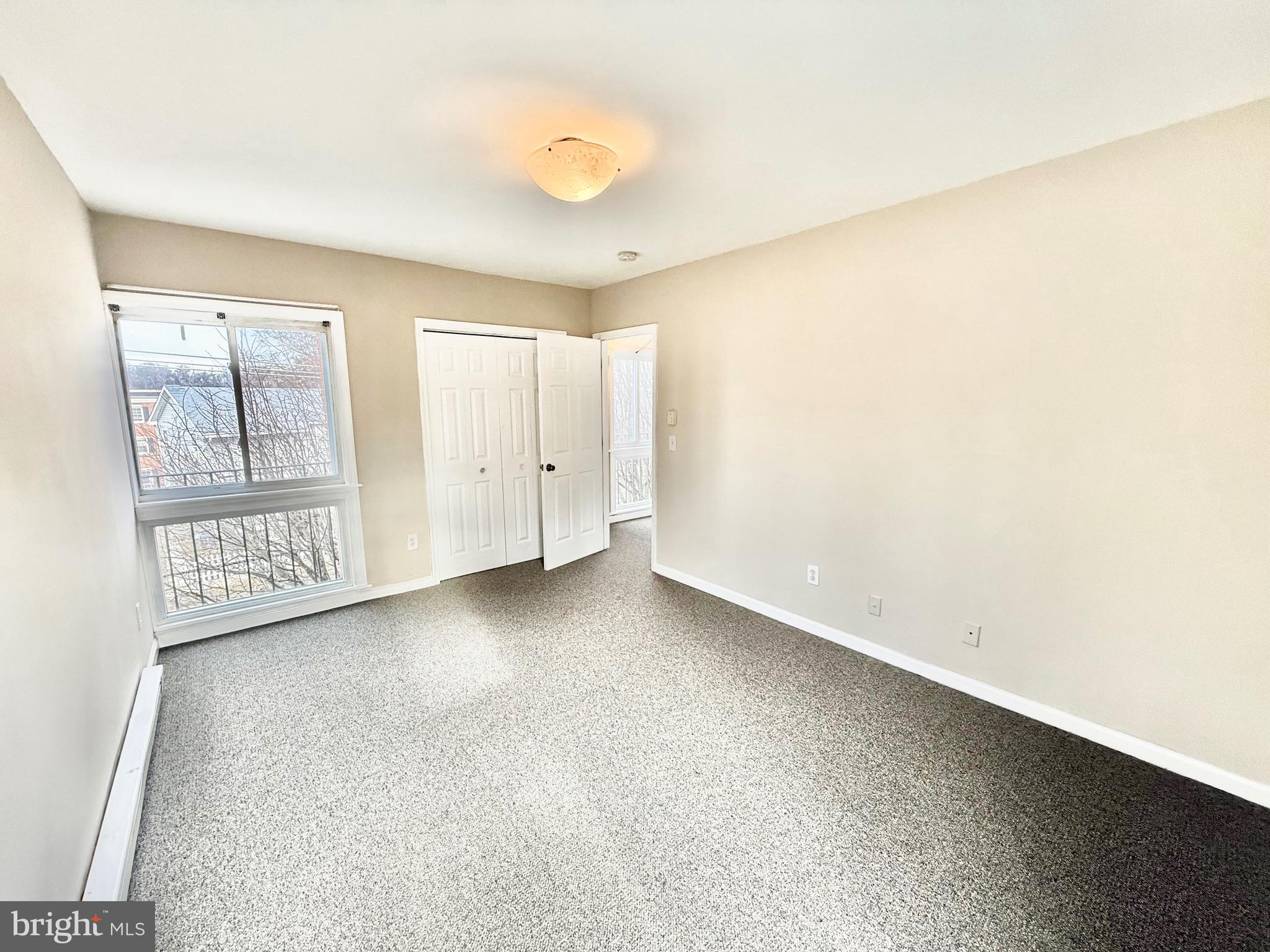 720 West Glebe Road, Unit 2C Alexandria, VA 22305 - Photo 8 of 13 an empty room with windows and closet