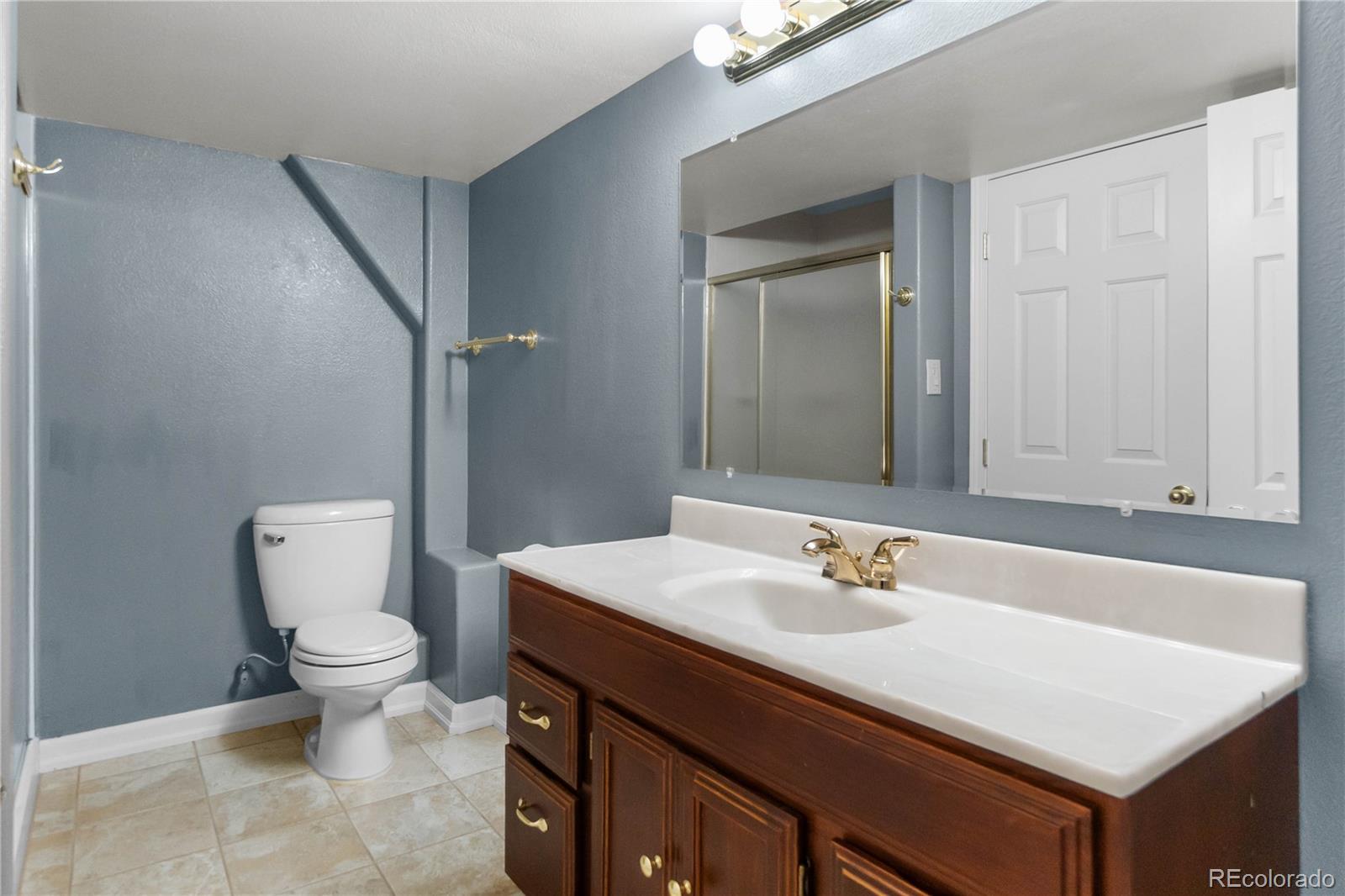 74 Rocky Cliff Road Elizabeth, CO 80107 - Photo 37 of 50 a bathroom with a sink toilet and a mirror