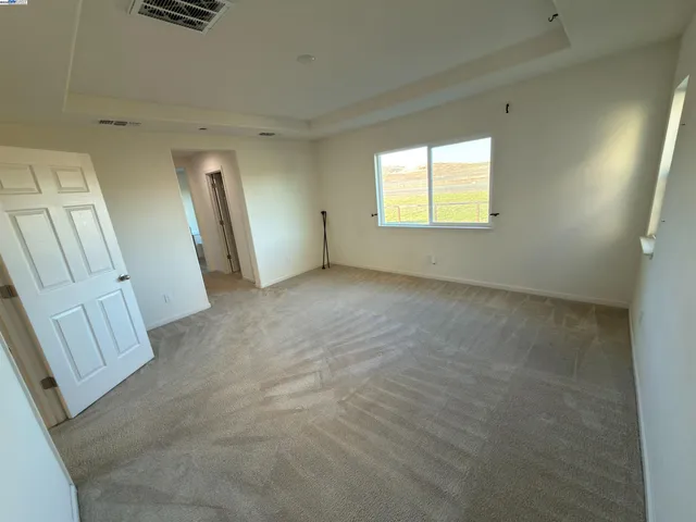 an empty room with a empty space and windows