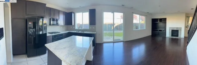 a kitchen with stainless steel appliances granite countertop a refrigerator and a sink