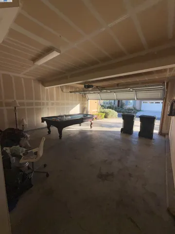 a front view of a house with a yard and potted plants