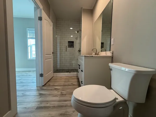 a bathroom with a toilet and a shower
