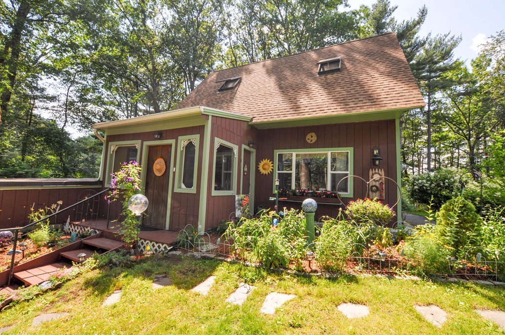 a front view of house with yard outdoor seating and barbeque oven