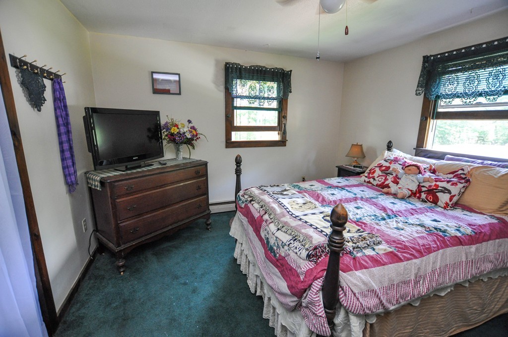 3 South Row Road Lunenburg, MA 01462 - Photo 12 of 29 a bedroom with a bed and a flat screen tv
