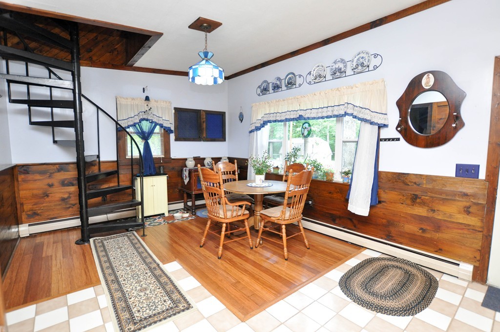 3 South Row Road Lunenburg, MA 01462 - Photo 6 of 29 a view of a dining room with furniture a chandelier and wooden floor