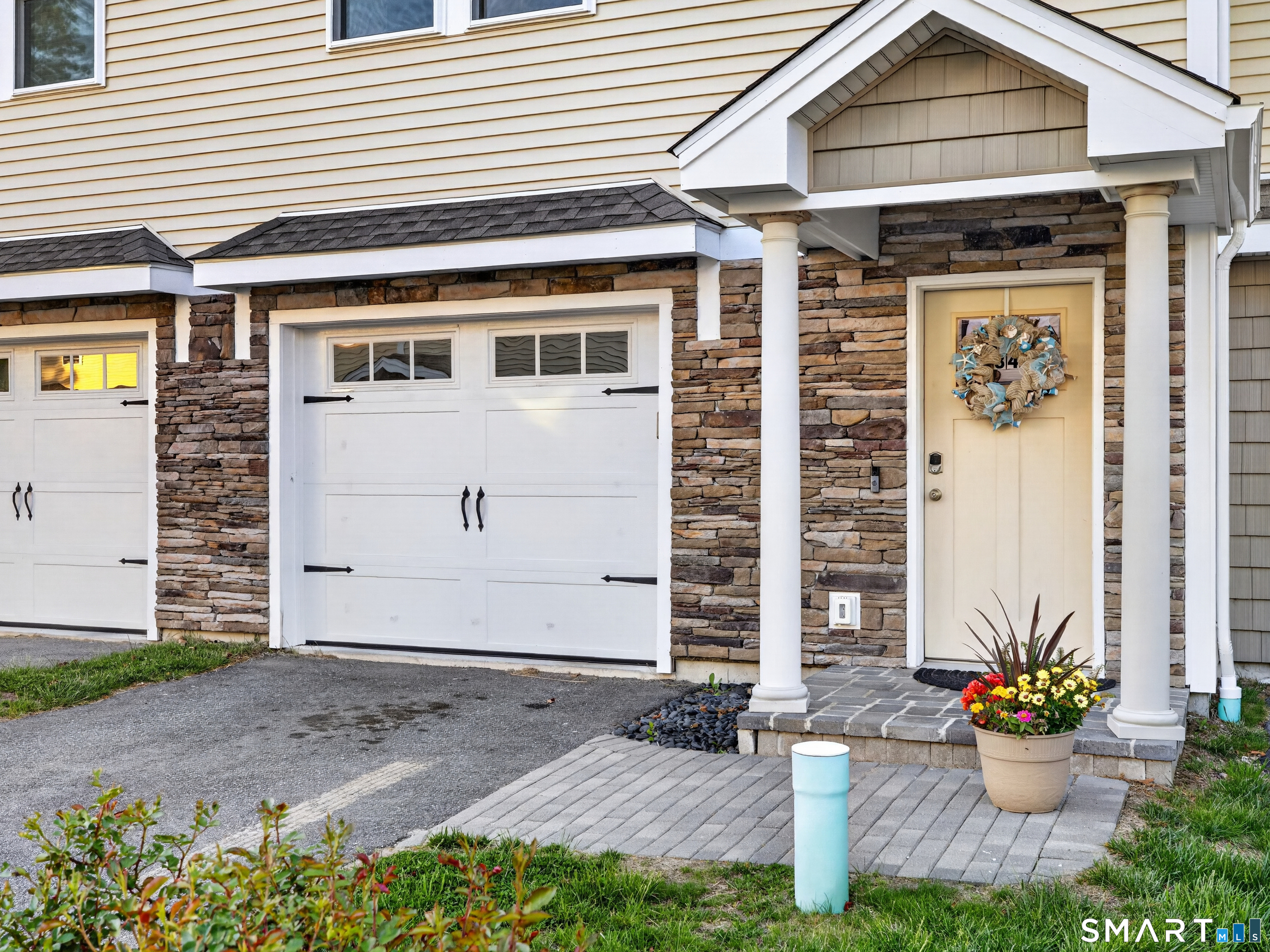 34 Village Crossing, Unit 34 Niantic, CT 06357 - Photo 2 of 38 a front view of a house with yard