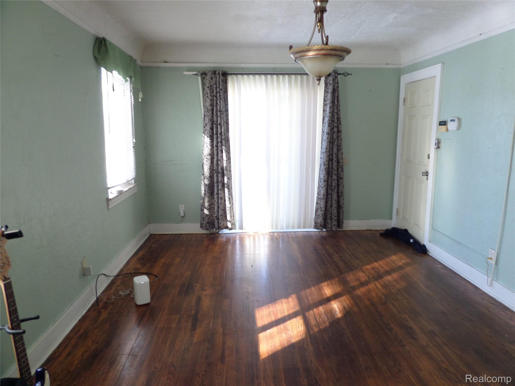 384 Perry Street Pontiac, MI 48342 - Photo 4 of 28 Unit 1 Spare room featuring dark wood-style flooring and baseboards