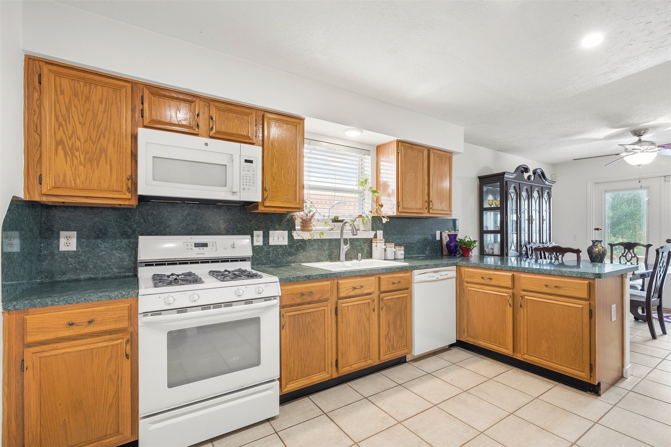 28723 Sedgefield Street Spring, TX 77386 - Photo 7 of 20 a kitchen with stainless steel appliances granite countertop a stove a sink and a microwave