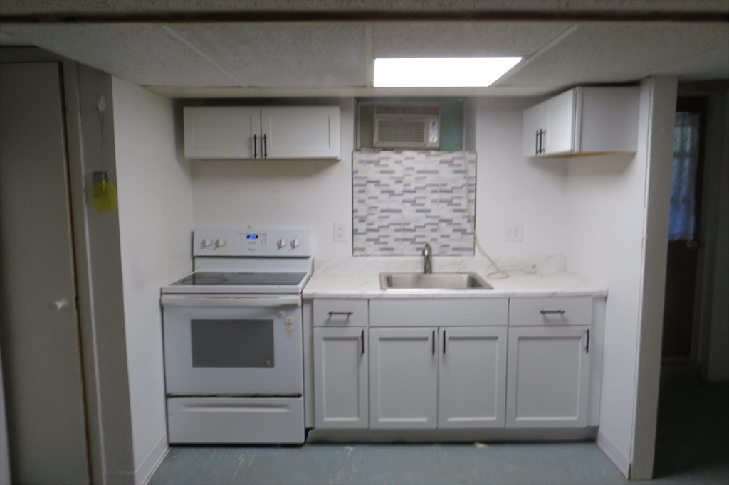 33 Coughlin Road Easton, MA 02356 - Photo 13 of 15 a kitchen with white cabinets and sink