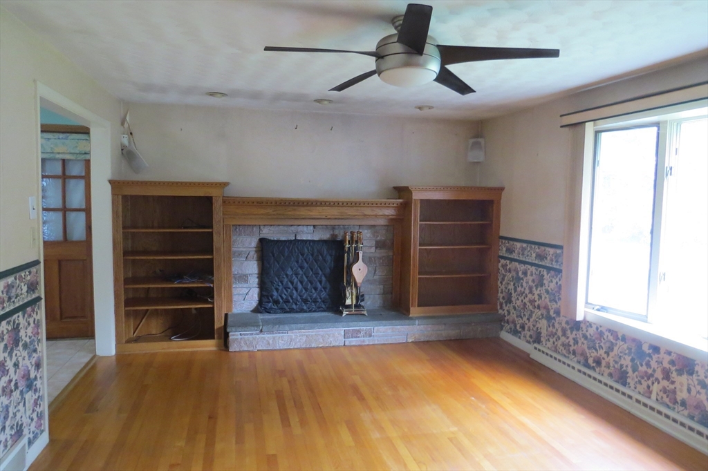 33 Coughlin Road Easton, MA 02356 - Photo 3 of 15 a living room with a fireplace cabinet and a large window