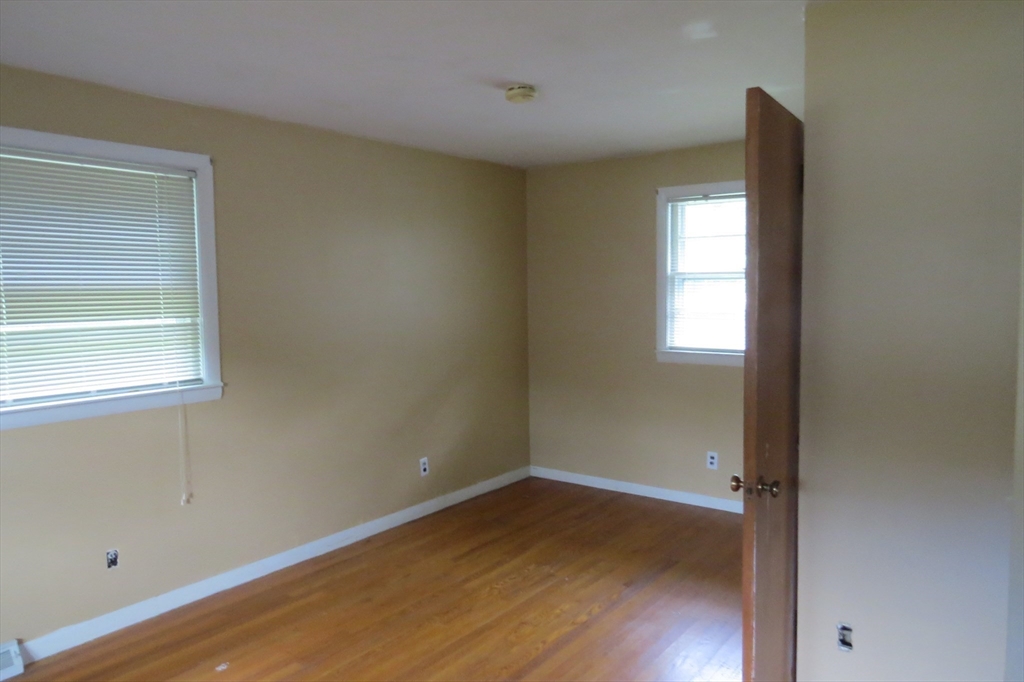 33 Coughlin Road Easton, MA 02356 - Photo 9 of 15 an empty room with wooden floor and windows