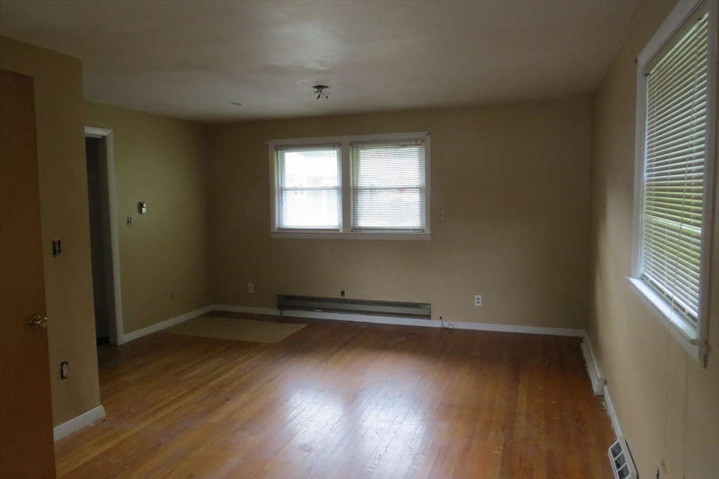 33 Coughlin Road Easton, MA 02356 - Photo 10 of 15 an empty room with wooden floor and windows