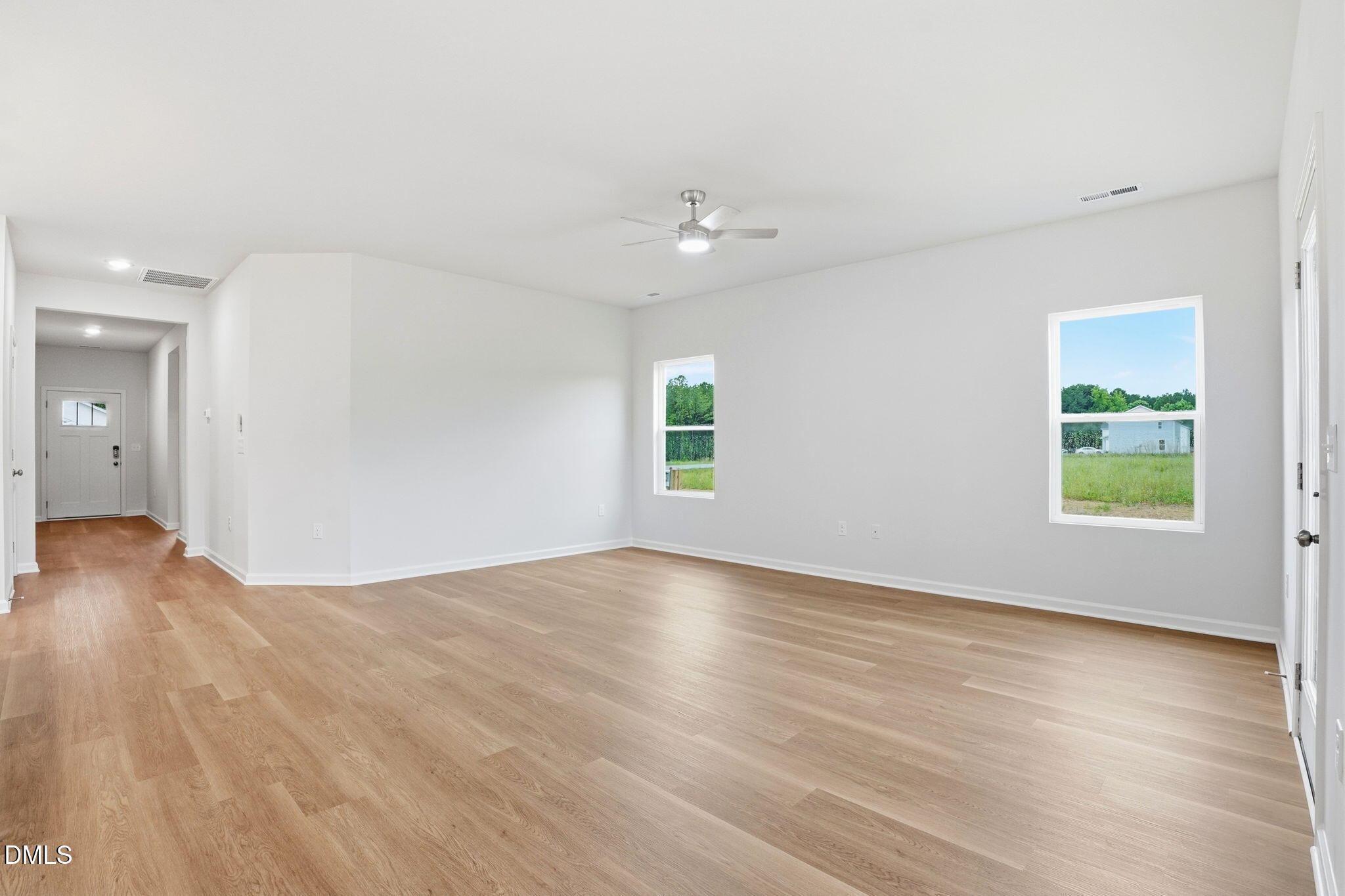 9019 Phoenix Court Spring Hope, NC 27882 - Photo 16 of 34 an empty room with wooden floor and windows
