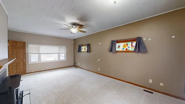 a view of a livingroom with a fireplace and window