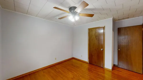 a view of an empty room with a ceiling fan