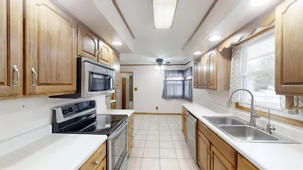 a kitchen with a refrigerator microwave and stove