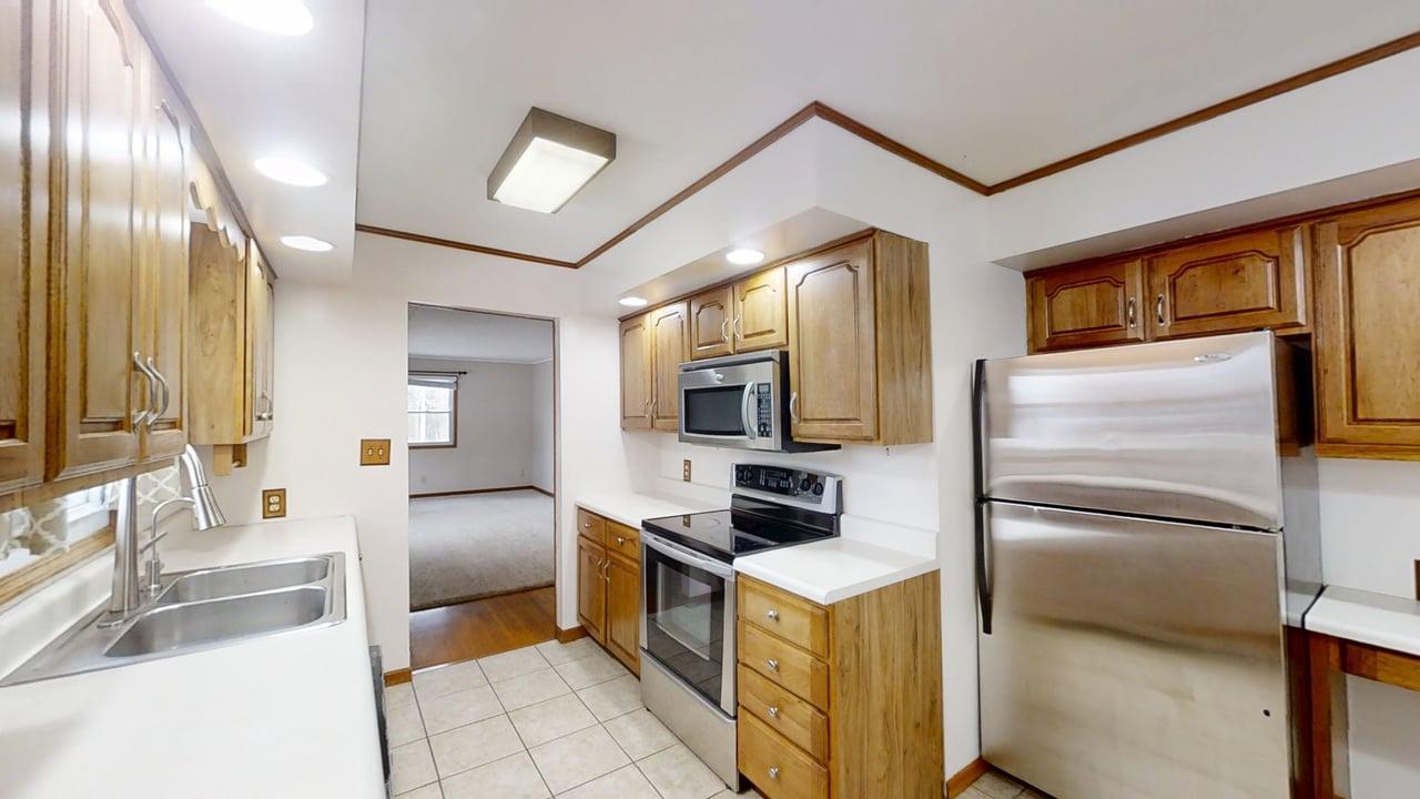 605 Douglas Street Catlin, IL 61817 - Photo 8 of 41 a kitchen with a refrigerator microwave and stove