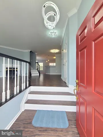 a view of staircase with white walls and a mirror
