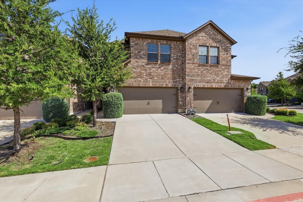 519 Sequoia Street Allen, TX 75002 - Photo 2 of 38 Brick two-story exterior featuring a two-car garage, concrete driveway, and established landscaping
