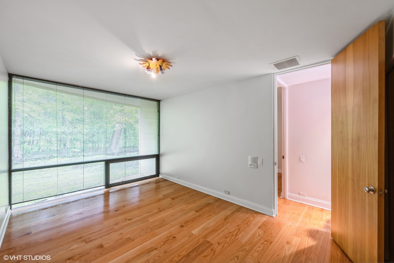 2000 Clendenin Lane Riverwoods, IL 60015 - Photo 22 of 51 wooden floor in an empty room with a window