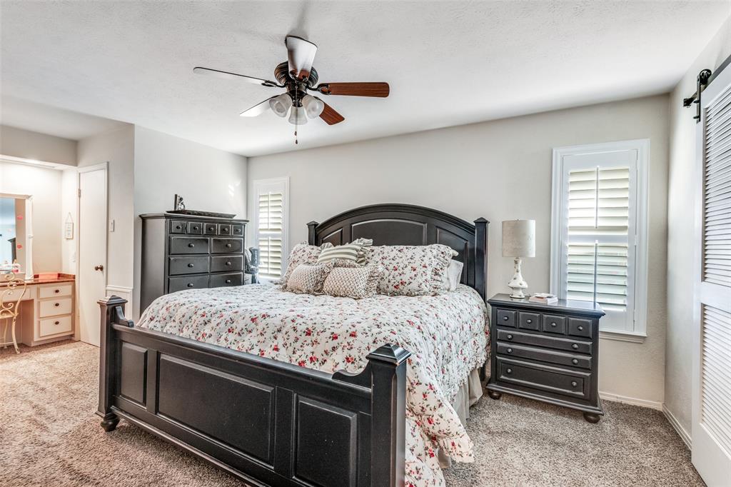 3946 Candlenut Lane Dallas, TX 75244 - Photo 14 of 25 a bedroom with a bed and dresser