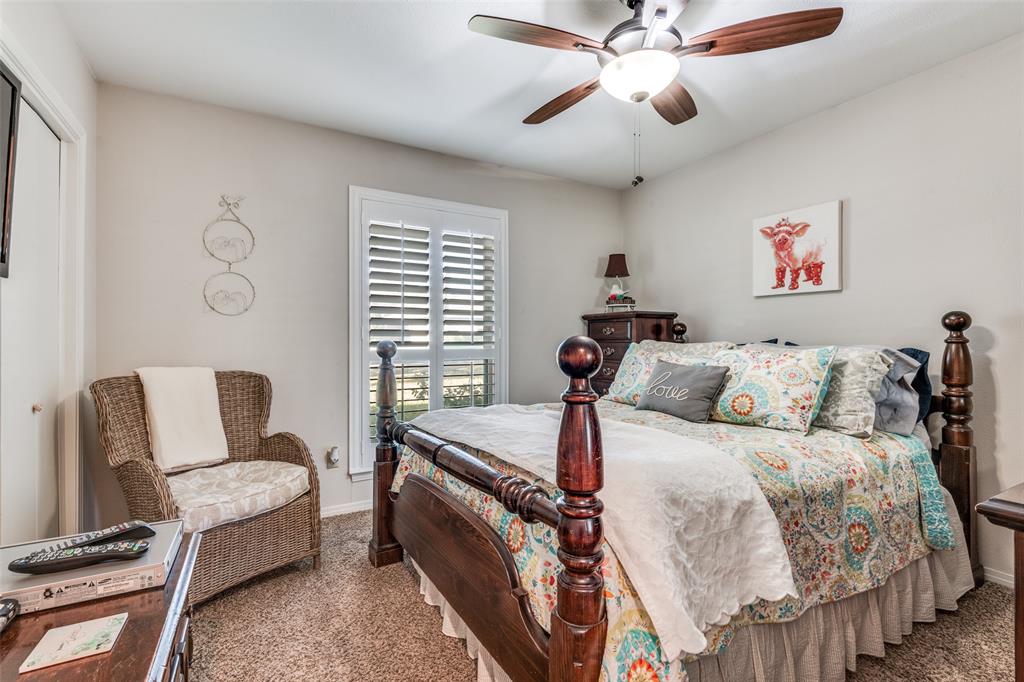 3946 Candlenut Lane Dallas, TX 75244 - Photo 16 of 25 a bed room with a bed and a chair