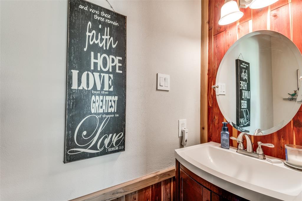 3946 Candlenut Lane Dallas, TX 75244 - Photo 19 of 25 a bathroom with mirror and a sink