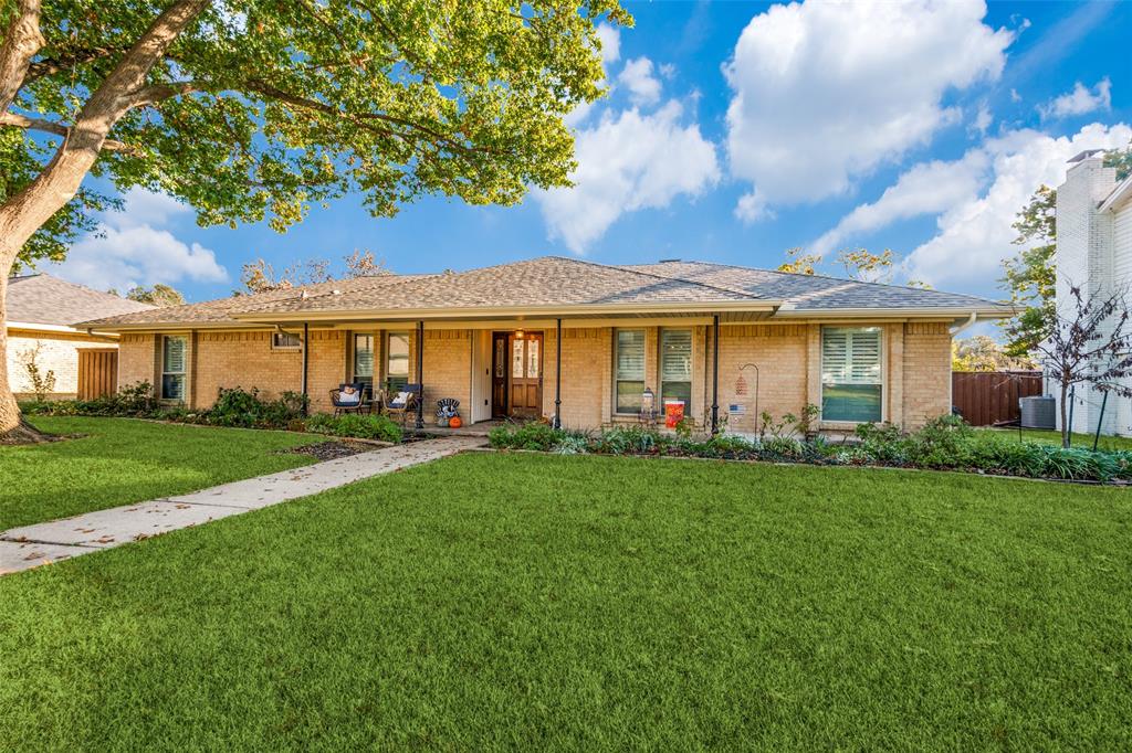 3946 Candlenut Lane Dallas, TX 75244 - Photo 2 of 25 a front view of a house with a yard