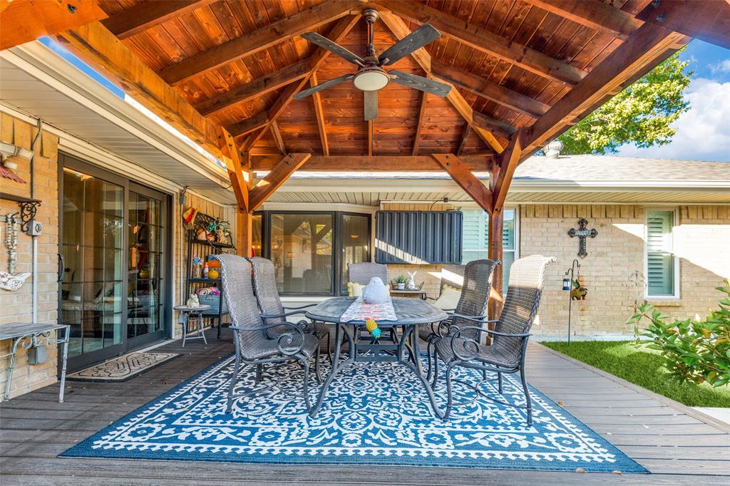 3946 Candlenut Lane Dallas, TX 75244 - Photo 22 of 25 a view of a patio with a table and chairs