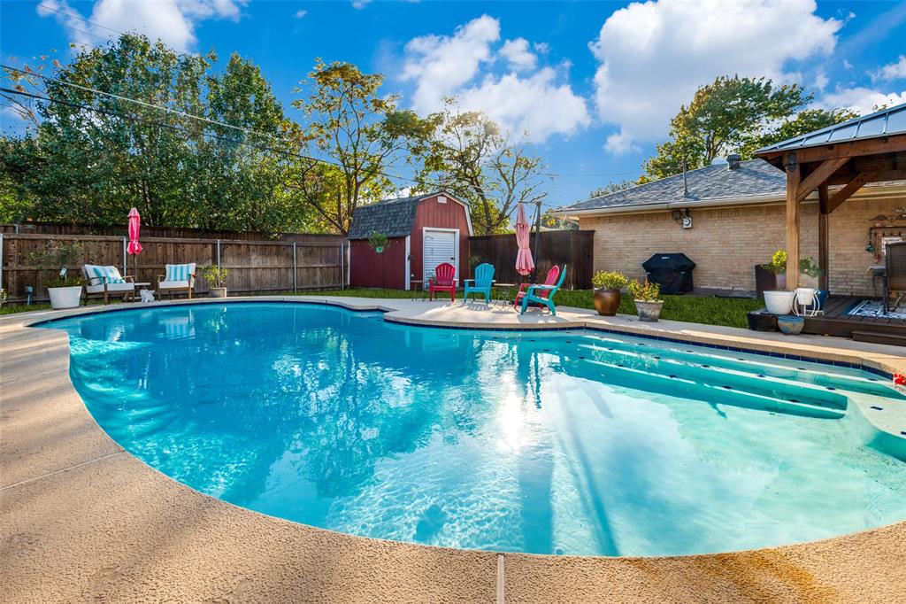 3946 Candlenut Lane Dallas, TX 75244 - Photo 25 of 25 a view of a swimming pool with a sitting space