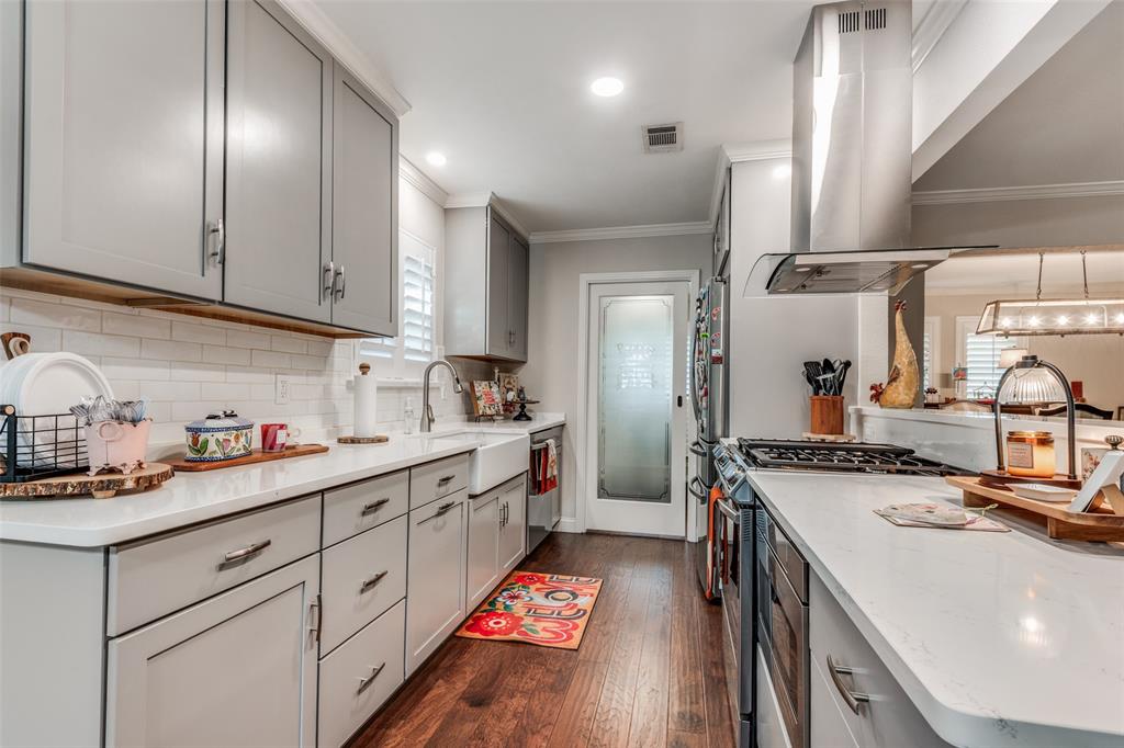 3946 Candlenut Lane Dallas, TX 75244 - Photo 10 of 25 a kitchen with a sink stove and cabinets