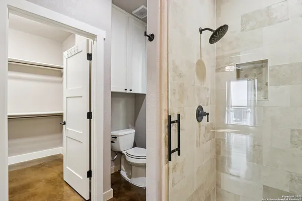 a bathroom with a shower and a toilet