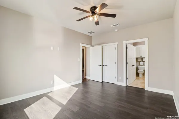 a view of an empty room with wooden floor