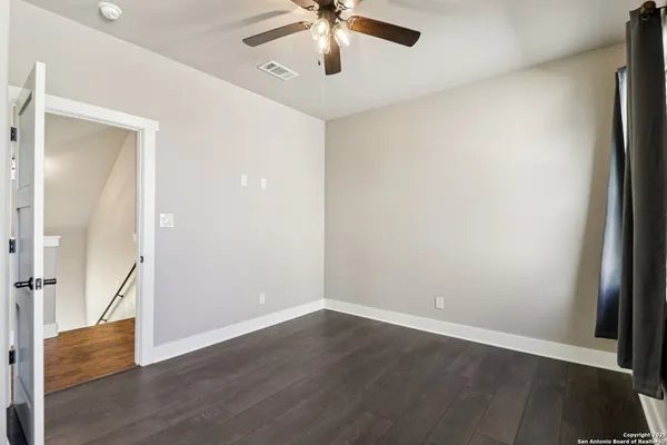 wooden floor in an empty room with a window