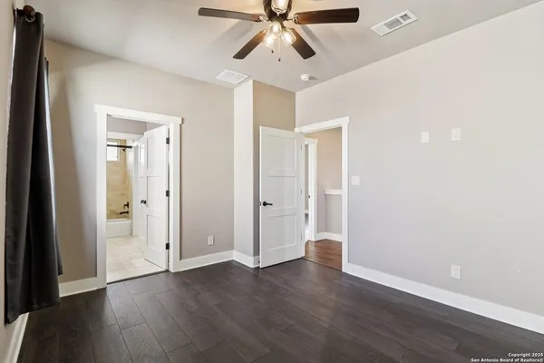 a view of an empty room and wooden floor
