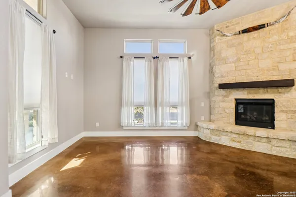 a view of empty room with wooden floor and fireplace