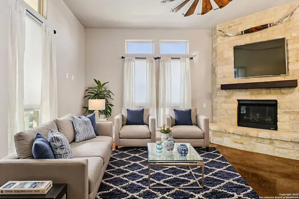 a living room with furniture and a fireplace