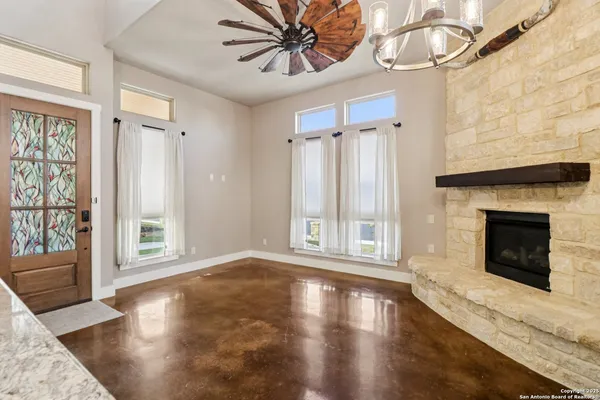 a view of a livingroom with wooden floor and a fireplace