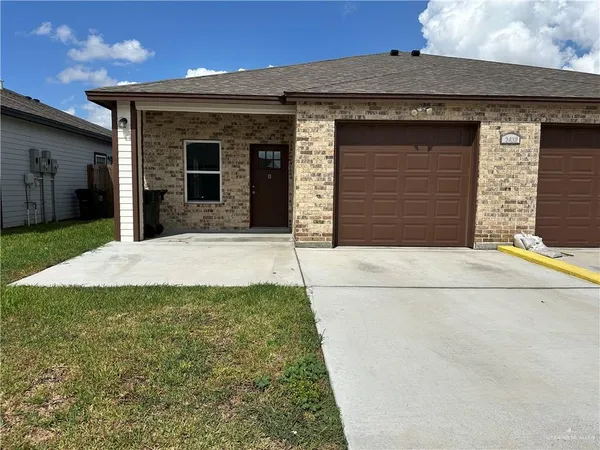 a view of a house with a small yard