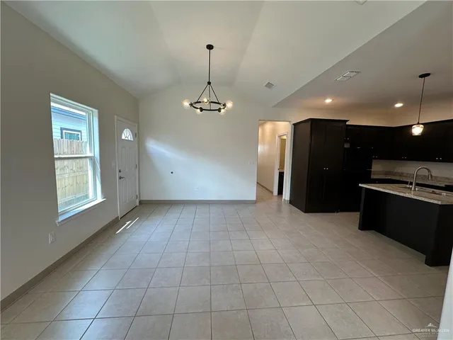 a view of kitchen with windows and refrigerator