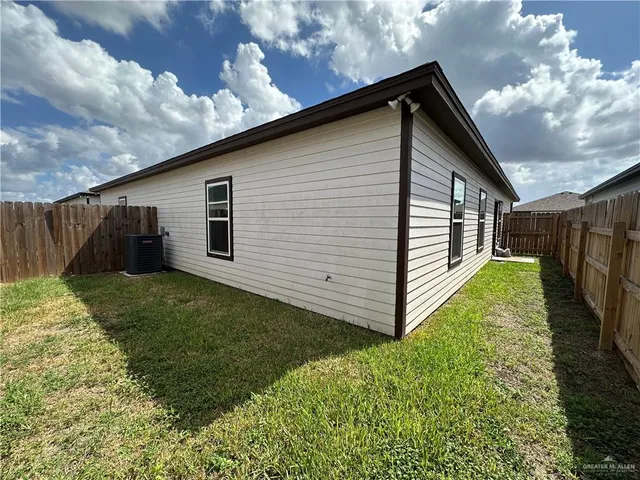 a backyard of a house with lots of green space