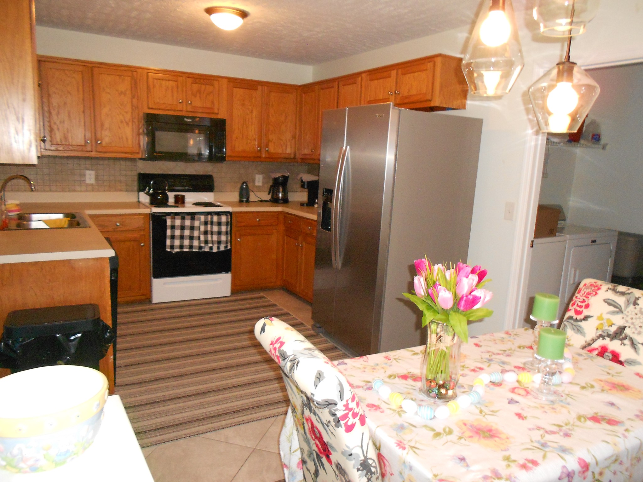 331 Chrissa Lane Lebanon, TN 37087 - Photo 5 of 20 a kitchen with stainless steel appliances kitchen island granite countertop a refrigerator a microwave oven a sink with dining table and chairs