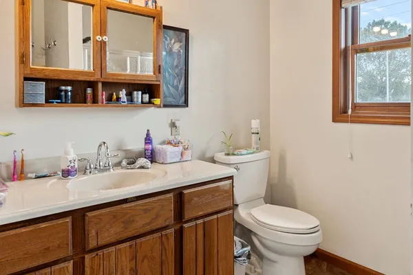 a bathroom with a sink toilet and a mirror