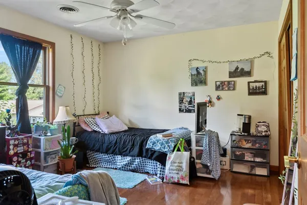 a bedroom with furniture and a large window