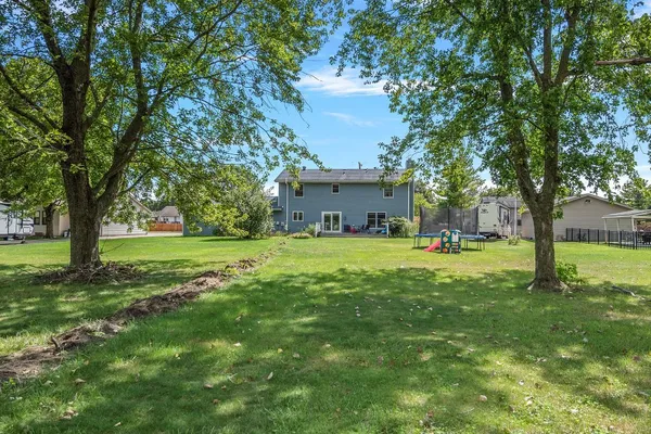 a view of house with a big yard