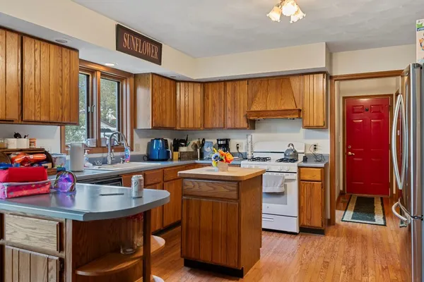 a kitchen with granite countertop a sink appliances and cabinets
