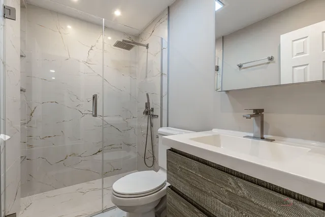 a bathroom with a sink toilet and shower